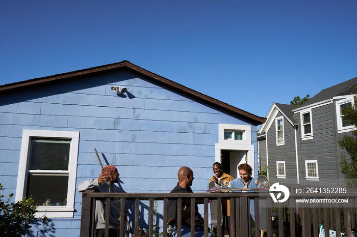 Four young skateboarders  hanging out and laughing