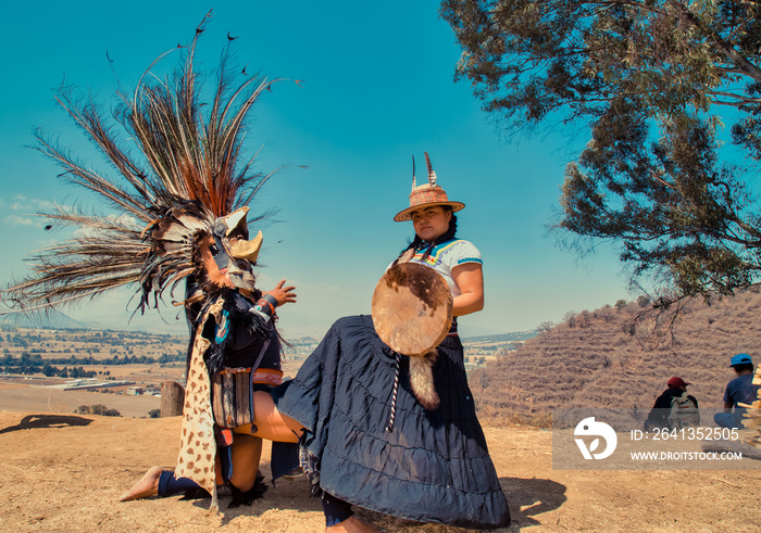 Mexican dancers posing at camera with tufts and pre-Hispanic dress