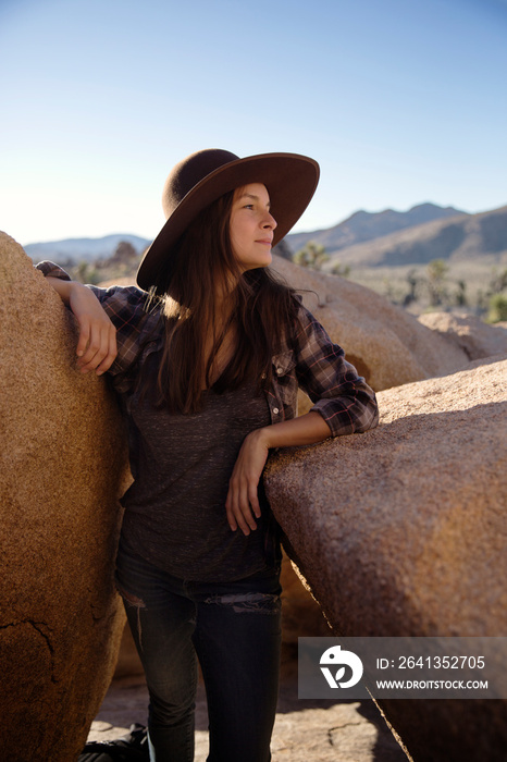 Young woman standing between rocks