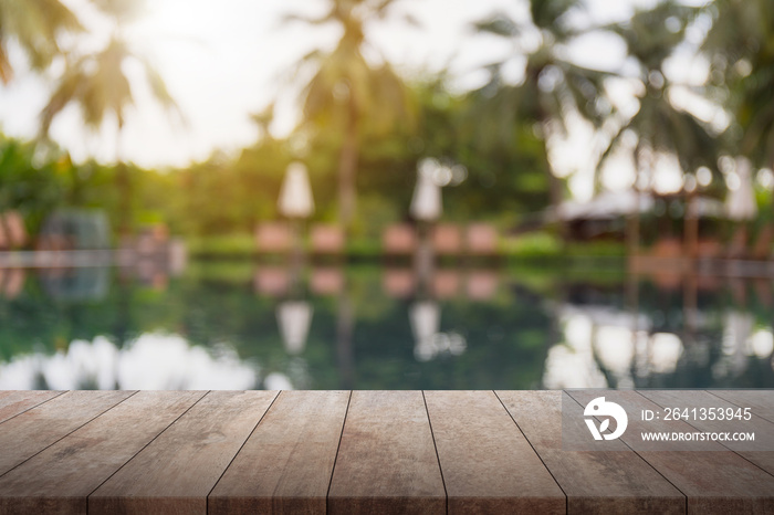 Empty wood table top and blurred swimming pool in tropical resort background. - can used for display