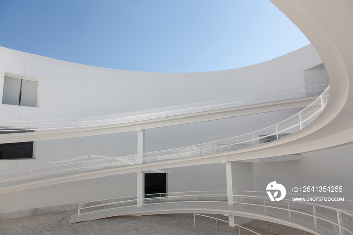 Winding ramps in modern building courtyard