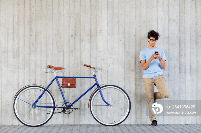 man with smartphone and fixed gear bike on street