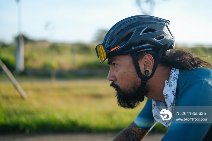 A bearded cyclist riding his bike.