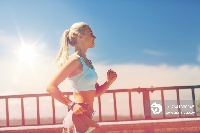 smiling young woman running outdoors