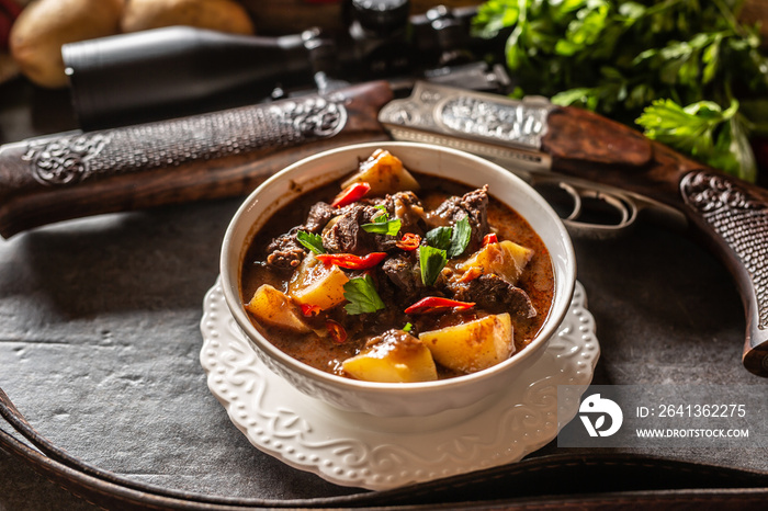 Deer stew in a bowl hunting weapon as a decoration