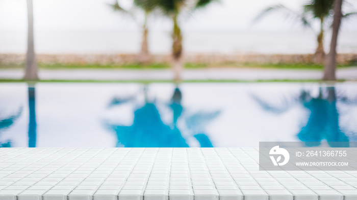 Empty white ceramic mosaic table top and blurred swimming pool in tropical resort in summer banner b