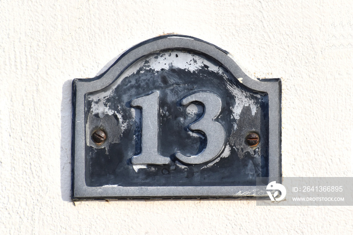 House number thirteen (13). Address number.