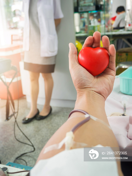 Nurse receiving blood from blood donor in hospital.