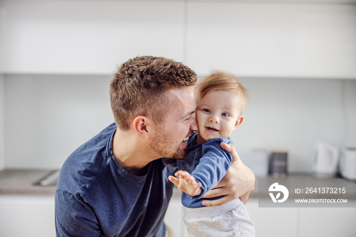 Young happy father hugging his adorable beloved son.