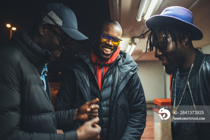 three african men standing in the street and having conversation