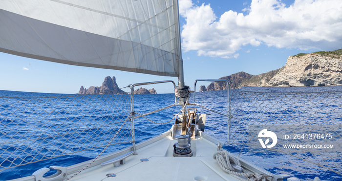 Panoramic prow of a sailboat navigating in the mediterranean sea close to Ibiza island. Summer vacat