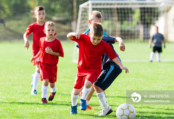 Boys kicking ball