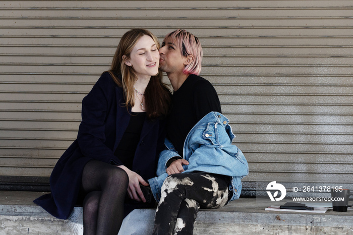 Lgbtqia friends sitting and posing together.