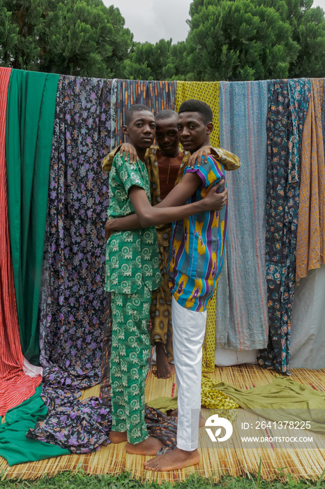 Two nigerian brothers in ankara carrying youngest sibling