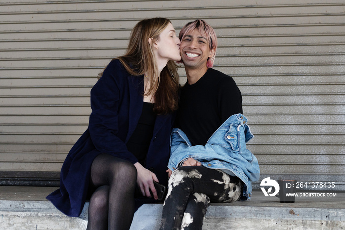 Lgbtqia friends sitting and posing together.