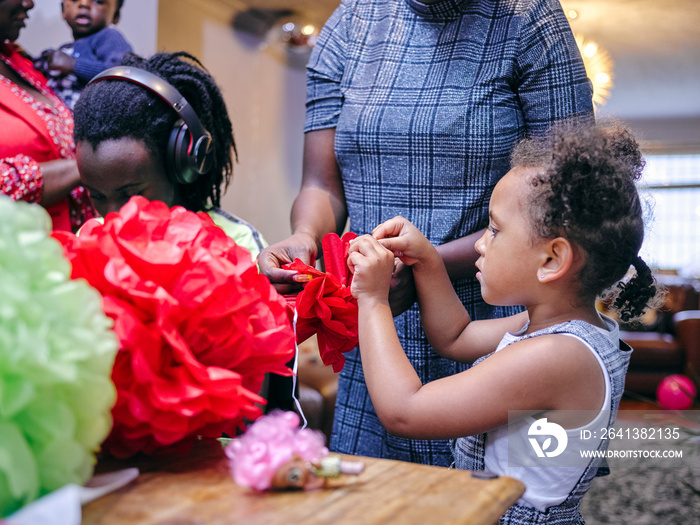 Family with children making paper decorations