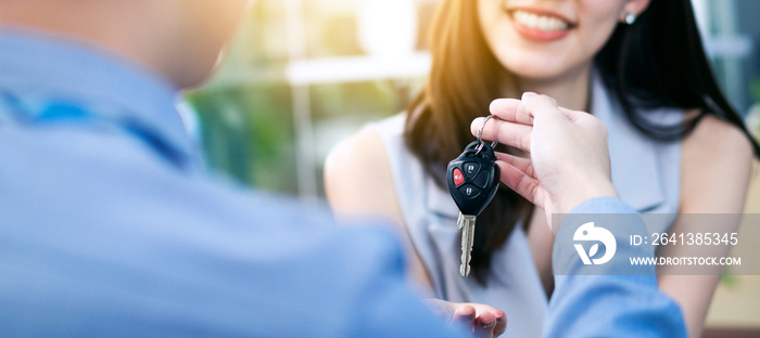 banner of Happy Asian woman receiving remote from dealer sales man for buy new car, or vehicle renta