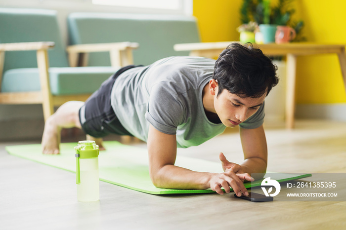 Asian man doing exercise at home