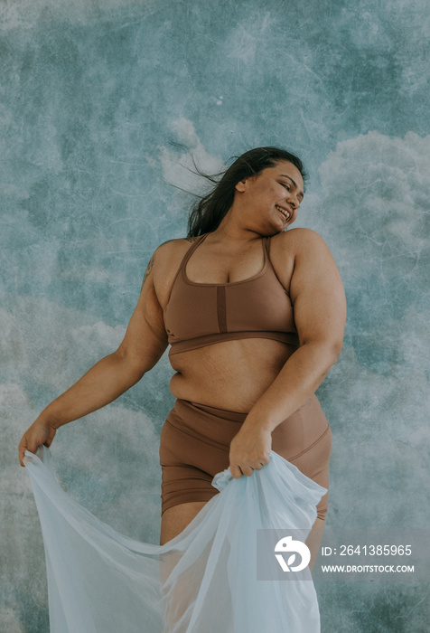 East Indian woman dancing with blue fabric