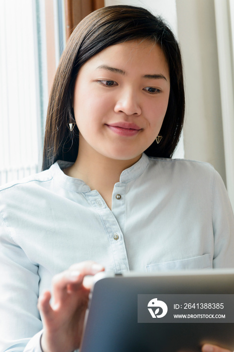 Close up of woman using digital tablet