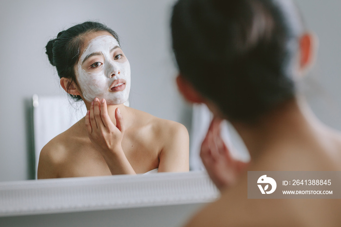 Woman doing beauty treatment in bathroom