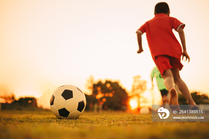 Silhouette action sport outdoors of diversity of kids having fun playing soccer football for exercis