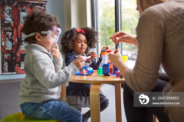 Children (2-3, 4-5) playing with toys