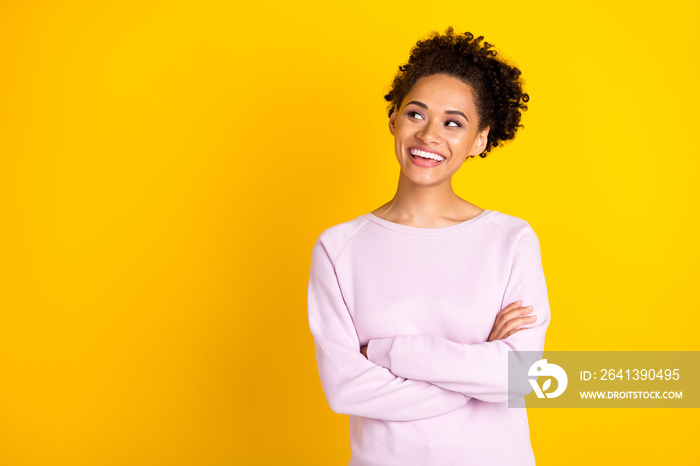 Photo of happy positive charming afro american woman look empty space smile isolated on yellow color