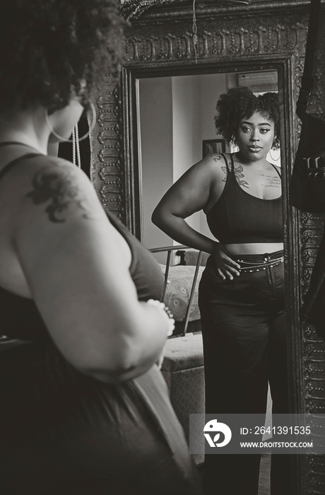 Black woman admiring herself in the mirror