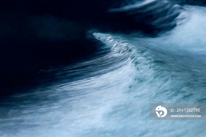 Stylized photograph of the close up of a wave from a boat wake