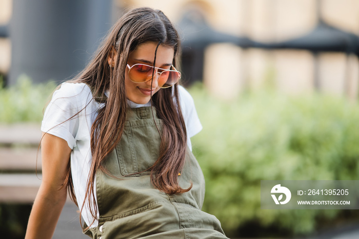 Young woman on a park bench posing at the camera