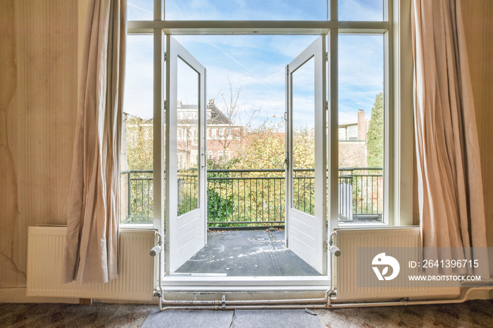 opened doors of the balcony of a classic house