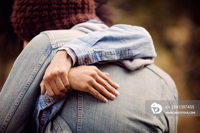 Hands of young woman embracing boyfriend