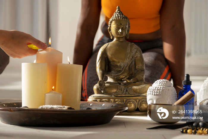 Close-up�of woman igniting candles in yoga studio