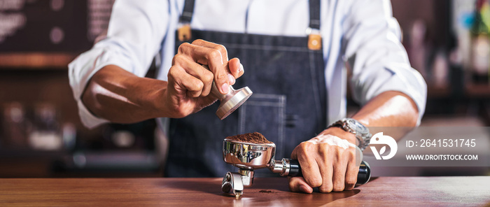 Banner of Asian Barista tamping the portafilter and preparing cup of coffee, espresso with latte or 