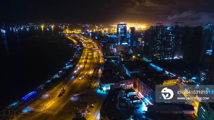 Road, lights and sea at night. Luanda city captured from the top