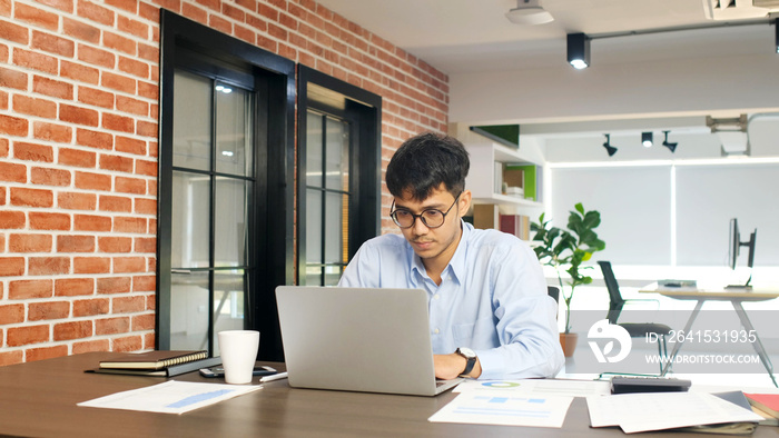 Young asian businessman concentrate on working with laptop computer at office, Asian office man comt