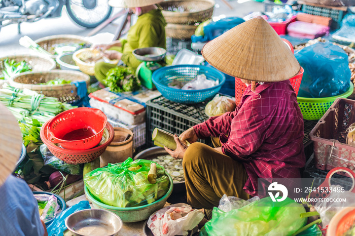 Women selling food on the street of Hoi An, Vietnam