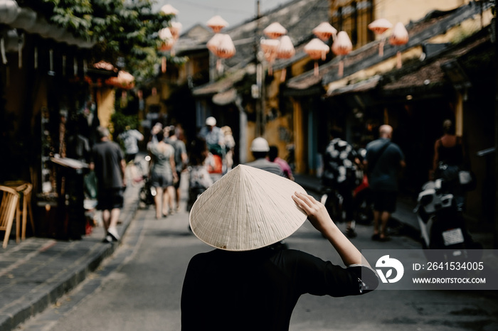 Tourist woman wearing vietnam hat or Non La and sightseeing at Heritage village in Hoi An city in Vi