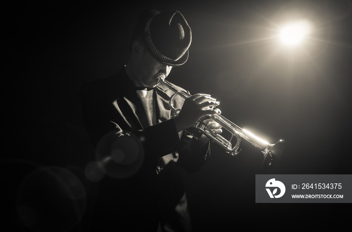 Musician playing the Trumpet with spot light on the stage