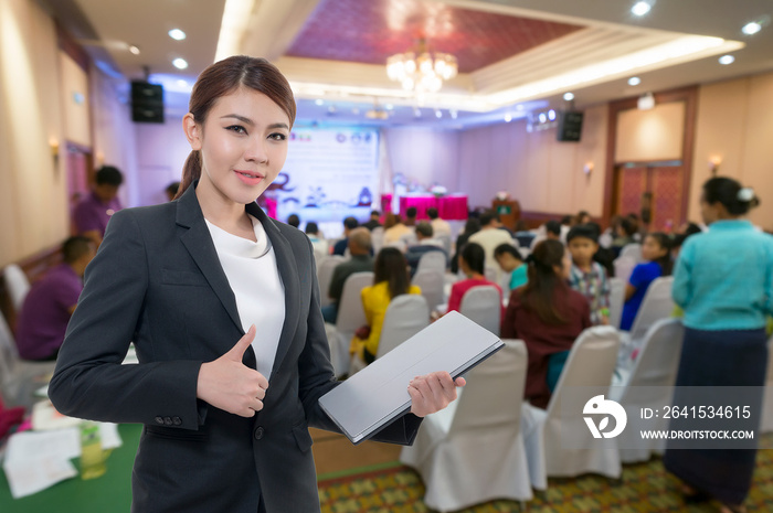 Beautiful asian working woman on the Abstract blurred photo of conference hall or seminar room with 