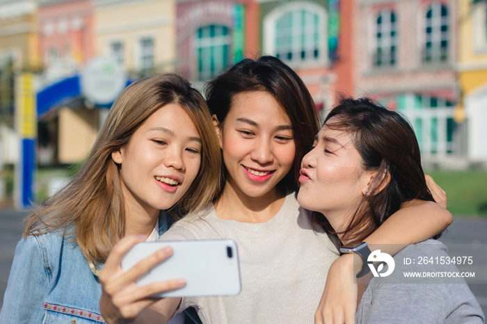 Attractive beautiful asian friends women using a smartphone. Happy young asian teenage at urban city