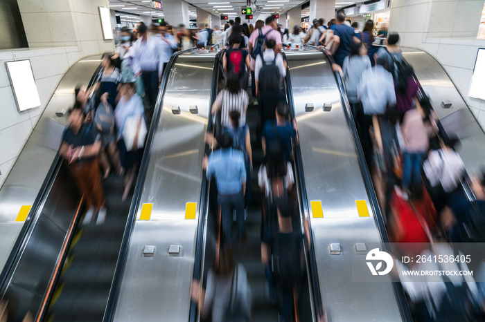 Crowd of Pedestrians Unrecognizable walking in escalator in rush hour morning before working time in