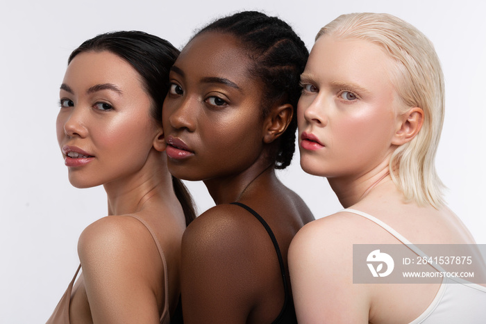 Women with three shades of skin color having open shoulders