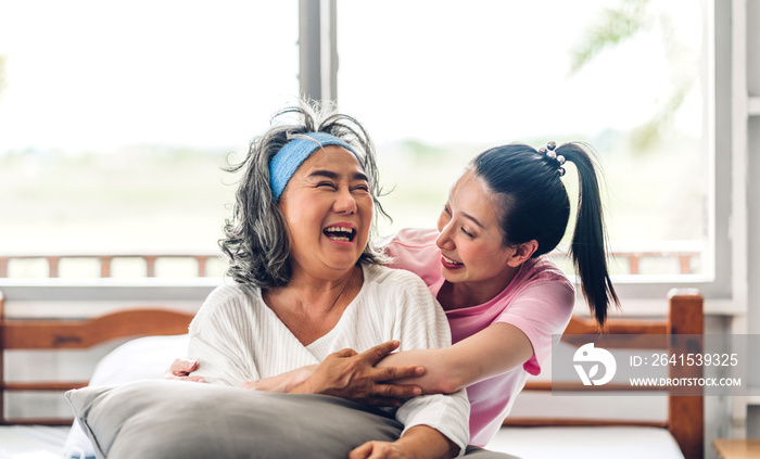 Portrait of enjoy happy love asian family senior mature mother and young daughter smiling laughing e