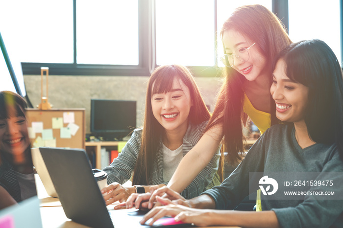 Group of happy asian creative team brainstroming and working together by computer notebook at creati