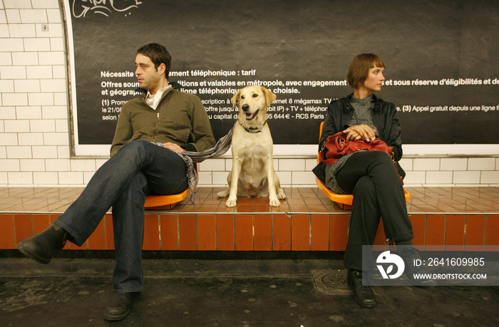 couple in underground station with their dog,