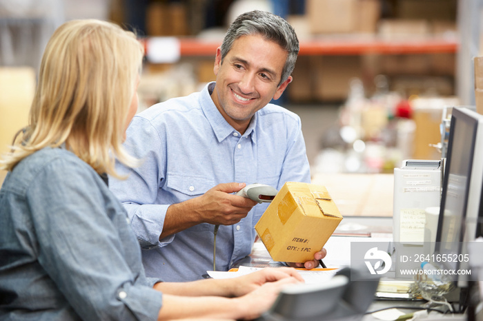 Business Colleagues Working At Desk In Warehouse