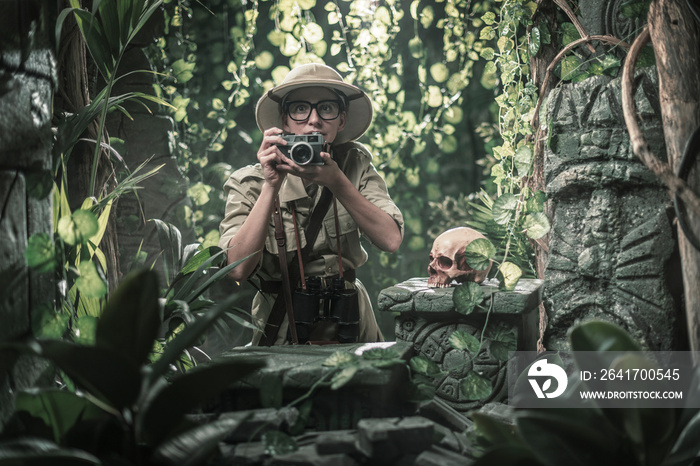 Brave explorer shooting pictures in the tropical forest