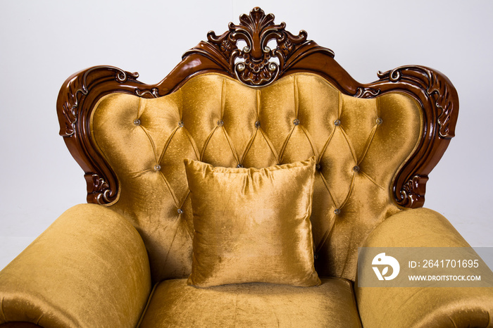 Close up of detail Luxurious vintage gold armchair on white background